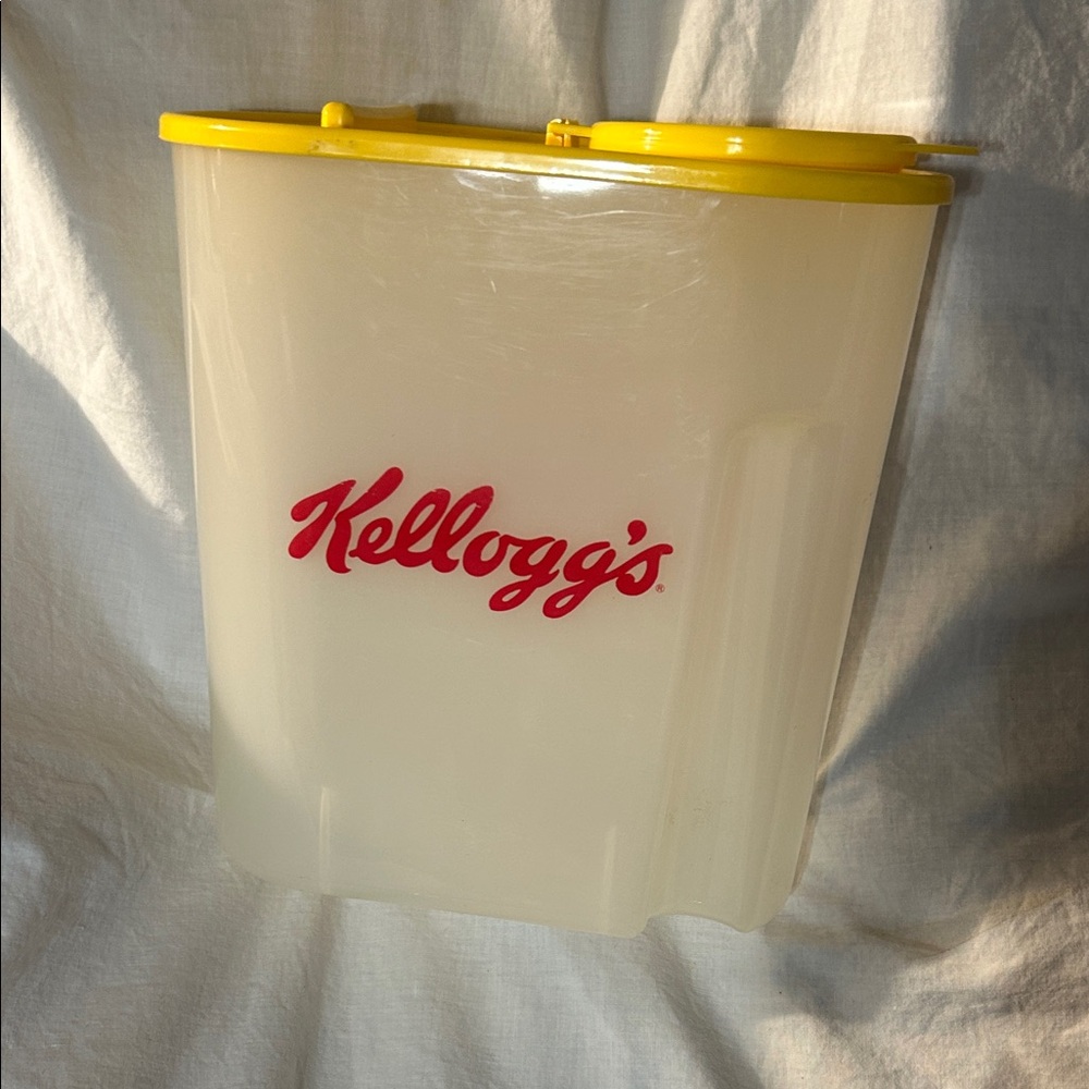 Vintage Kellogg’s cereal container.clear container, yellow lid, red letters